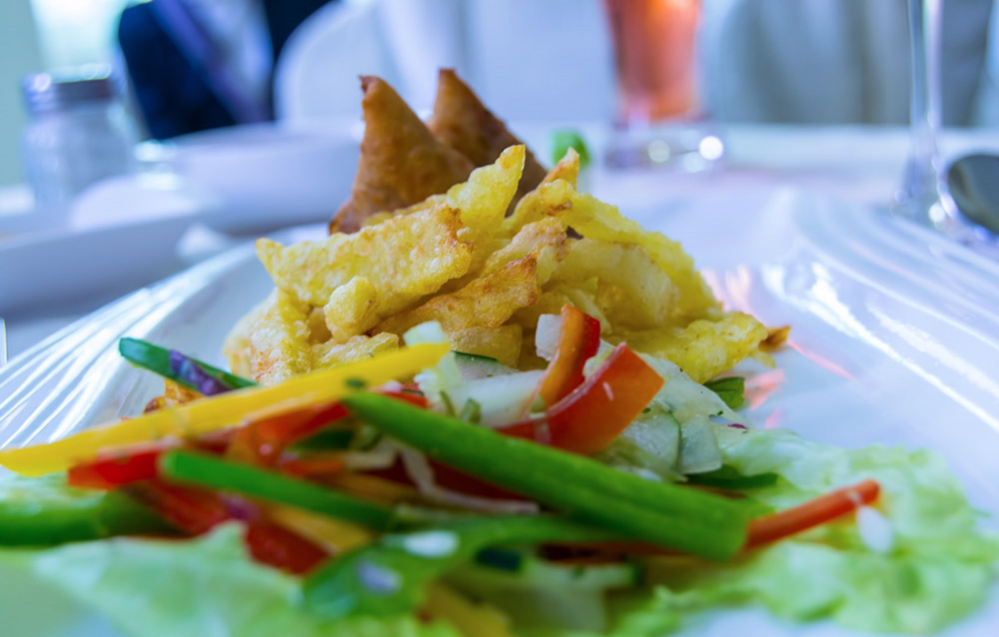 A plate of food with fried items and vegetables.