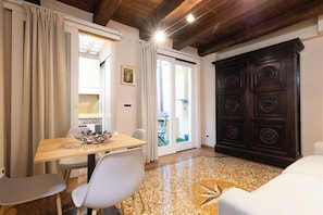 A dining area with a table, chairs, and a decorative metal bowl.