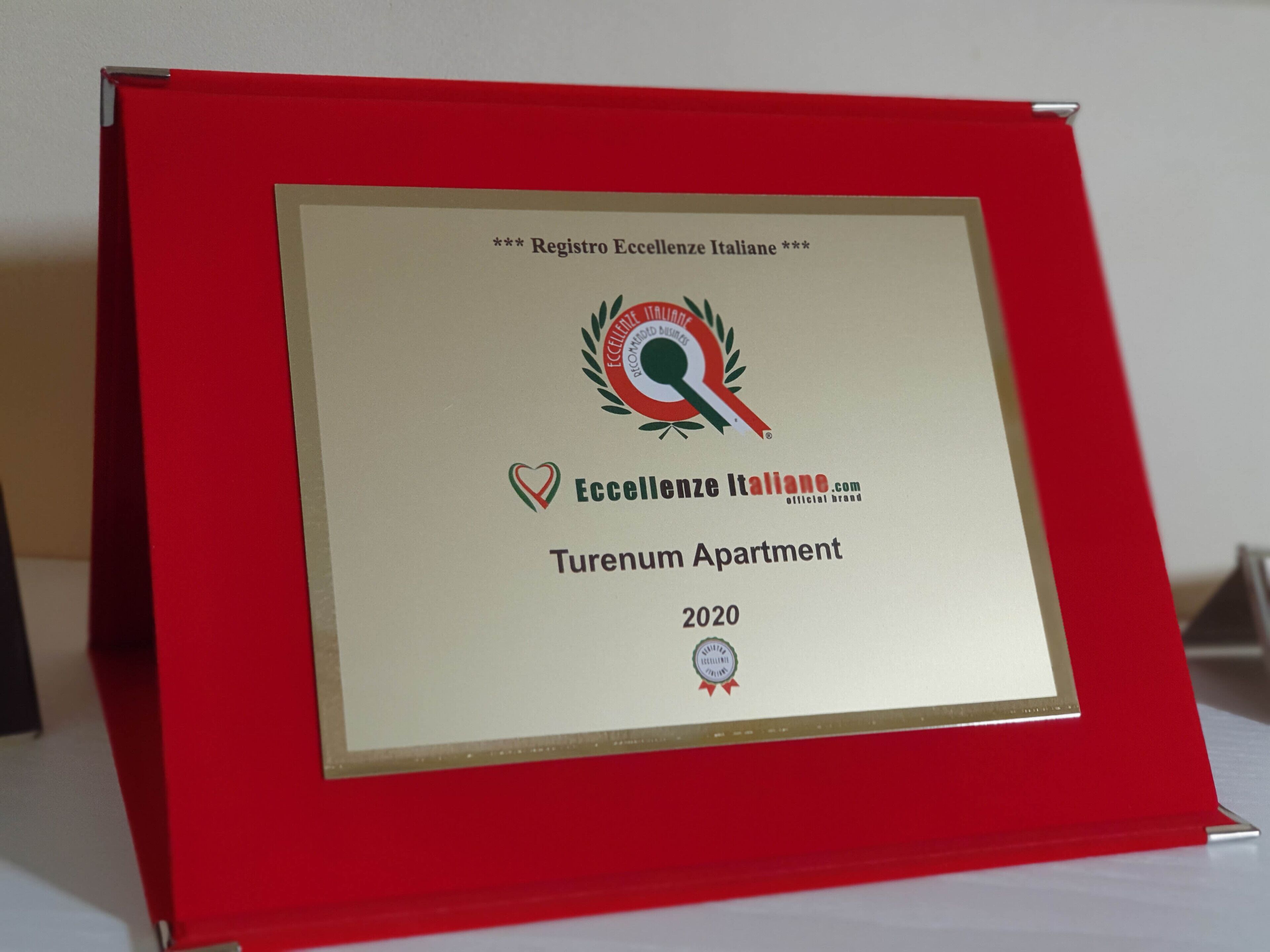 A framed certificate for a Turenum Apartment, awarded by Registro Eccellenze Italiane in 2020.