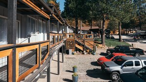 A building with a wooden deck and a staircase leading to a covered area. - Summit View Inn (Mount Shasta)