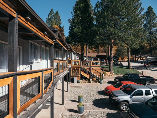 A building with a wooden deck and a staircase leading to a covered area. - Summit View Inn (Mount Shasta)