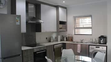 Comfort Condo, Multiple Beds, Non Smoking, Garden View | Private kitchen | Full-size fridge, microwave, oven, stovetop