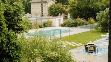 Seasonal outdoor pool, open 8:30 AM to 8:00 PM, pool umbrellas