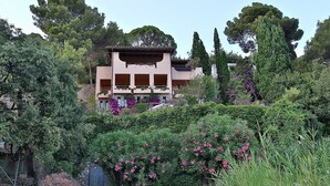 A multi-story building with a garden in front. - Monte Argentario, Tuscany, whole villa with panoramic view. (Monte Argentario)