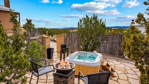 A backyard with a hot tub, stone patio, and outdoor seating area. - Amazing Views, Hot Tub, Pool, Sauna, Gourmet Kitchen, Master Suites!  (Santa Fe)