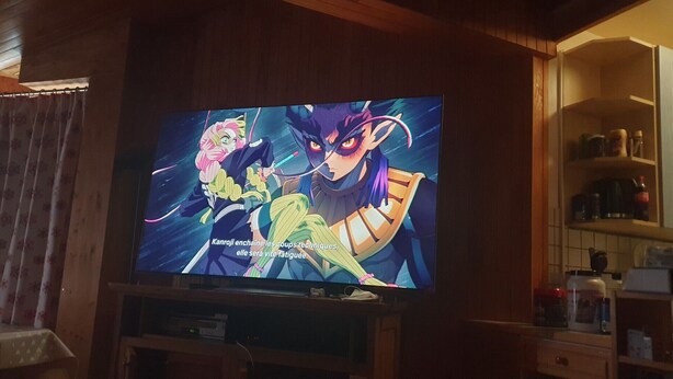 A television displaying an anime scene with characters in a kitchen setting. - Tignes Grand Appartement 10p Exceptional View Pied Des Pistes (Tignes)