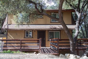 A two-story wooden cabin with a front porch, a covered entryway, and a small deck. - Secluded, Romantic Getaway. Perfect for Families Too! (Pine Mountain Club)