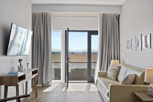 Suite, Patio, Ocean View | Living room | 52-inch flat-screen TV with cable channels, TV