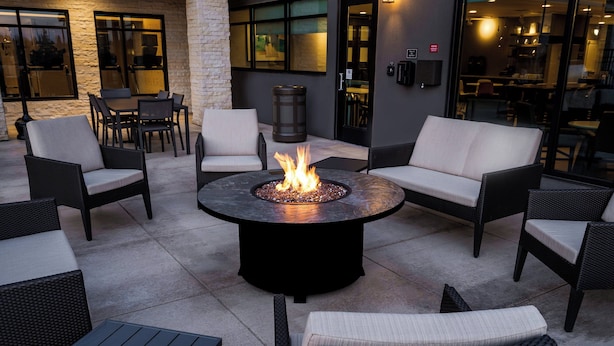 An outdoor seating area with a fire pit table surrounded by wicker chairs and sofas. - Residence Inn by Marriott Rocklin Roseville (Roseville)