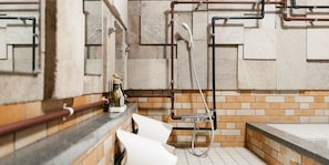 A bathroom with tiled walls, a shower area, and visible plumbing fixtures. - ALP Lodge (Hakuba)