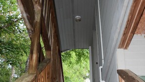 A wooden staircase leading to a covered area with a view of greenery outside. - Privacy, fishing, pool--Just 10 mins to beach/base (Sneads Ferry)