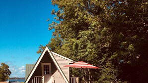 A swimming pool with a wooden deck, a barbecue grill, and a red umbrella. - Privacy, fishing, pool--Just 10 mins to beach/base (Sneads Ferry)