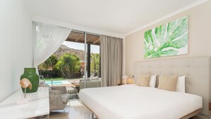 A hotel room with a large bed, a desk, and a view of a pool and mountains. - LUXURY PROPERTY, PRIVATE HEATED POOL, FREE FIBER WIFI (Mogán)