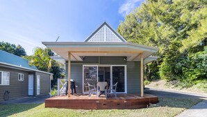 A small, single-story building with a sloped roof and a covered porch. - Sea Shell Chalet @ Berrara Chalet (Berrara)