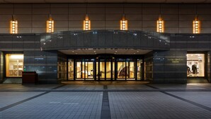 The entrance of Hotel Century Shizuoka with a glass door, a staircase, and a tiled pavement. - Hotel Grand Hills Shizuoka (Shizuoka)