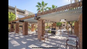 An outdoor patio area with brick columns, a pergola with patterned wood, and a grill. - Best Pool in the Area!- Walk to Everything Old Town! -2 Private Master Suites (Scottsdale)