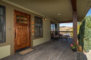 A wooden door with a glass panel, a porch with chairs, and a view of the landscape. - Modern Country Home 7 miles from mission ridge located in Wenatchee Heights (Wenatchee)