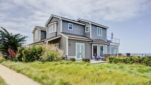 A two-story house with a covered porch and a view of the ocean. - Beach front Sea Loft in Santa Barbara.  Weekly discounts.  Best beach sunsets! (Carpinteria)
