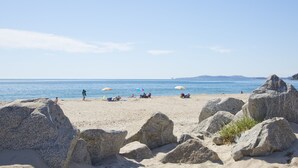 A beach with large rocks in the foreground, a clear blue sky, and the sea in the background. - Beach front Sea Loft in Santa Barbara.  Weekly discounts.  Best beach sunsets! (Carpinteria)