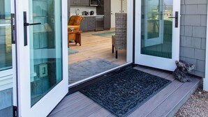 A modern home with a glass door leading to a kitchen and living area. - Beach front Sea Loft in Santa Barbara.  Weekly discounts.  Best beach sunsets! (Carpinteria)