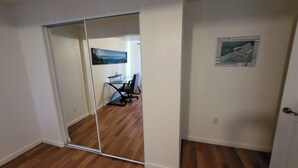 A room with a sliding glass door leading to a dining area with a table and chairs. - 2BR 1BA Condo in Roosevelt Row Arts District (Phoenix)