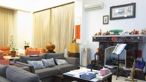 A living room with a sofa, coffee table, and a fireplace. - Annong RIver Homestay (Dongshan)
