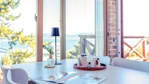 A table with a small plant, a lamp, and a tray with teapots and cups.