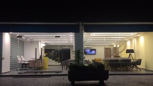 A modern interior with a reception desk, seating area, and a television. - B Residence (Beirut)