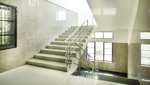 A modern staircase with metal railings, leading to a higher floor. - Sakthi Residency (Kumbakonam)