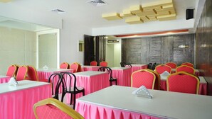 A conference room with tables and chairs, a hand wash station, and a no smoking sign. - Sakthi Residency (Kumbakonam)