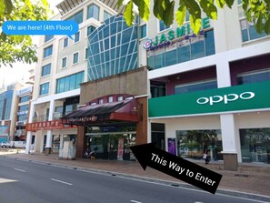 A commercial building with a massage center, a pharmacy, and an Oppo store. - Homy Seafront Hostel (Kota Kinabalu)