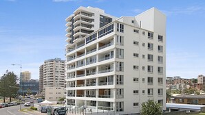 A multi-story residential building with balconies, a central courtyard, and a view of the surrounding urban area. - Rainbow Pacific Unit 8- Ocean views over Rainbow Bay Coolangatta with free Wi-Fi (Coolangatta)