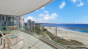 A balcony with a glass railing overlooking a beach and ocean. - Reflections On The Sea Unit 1501 On Coolangatta Beach, Ocean and Coastline views with Wi-Fi Inc. (Coolangatta)