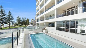 A modern hotel with a pool area, multiple balconies, and a view of the beach. - Rainbow Pacific Unit 9- Stunning views over Rainbow Bay and Snapper Rocks. Swimming Pool. Wi-Fi (Coolangatta)
