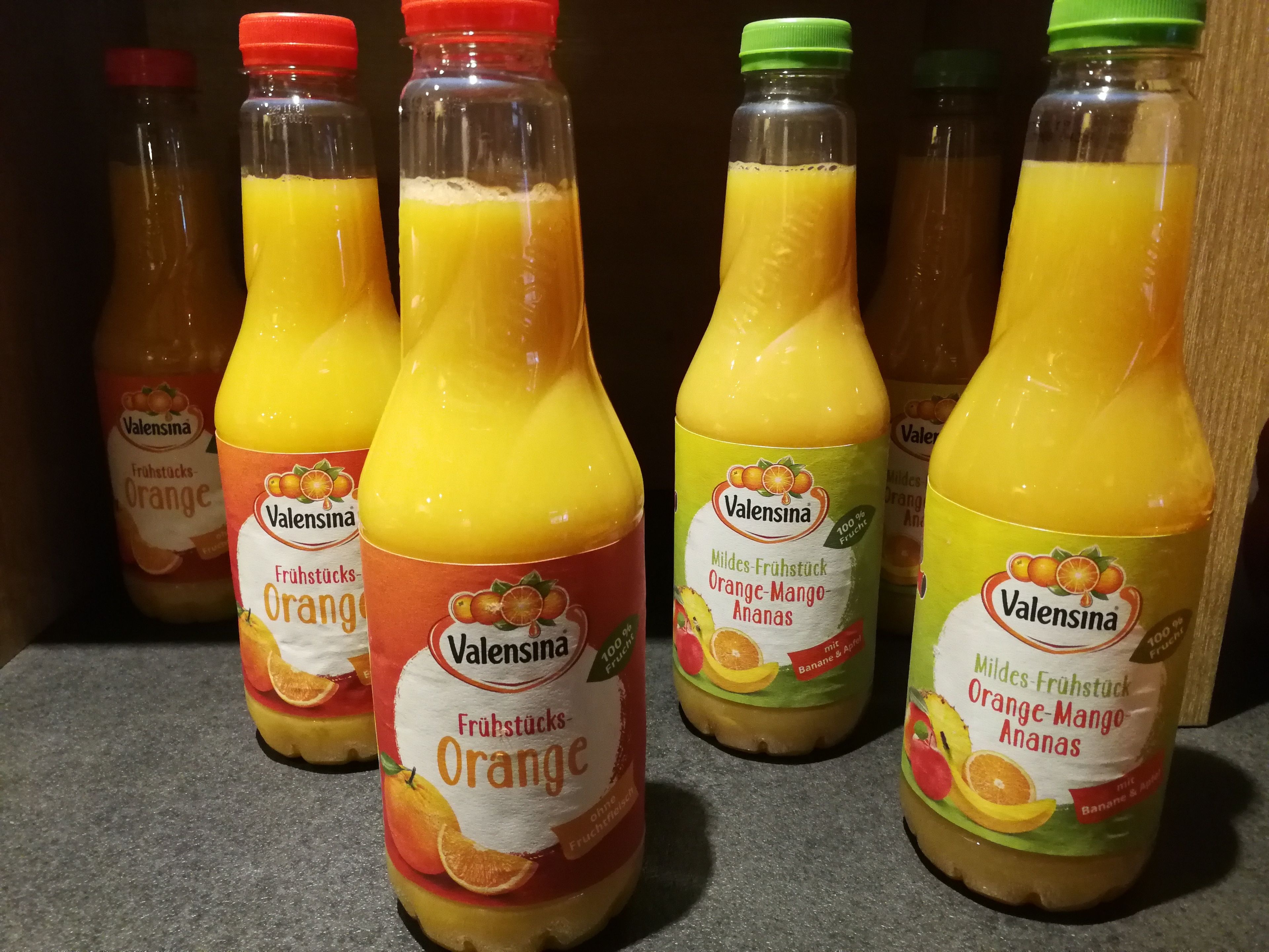 Bottles of Valensina fruit juices on a shelf.