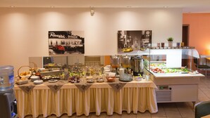 Dispositiu de menjar a gran bufet amb diversos plats i begudes, un dispensador d'aigua i un frigorífic.