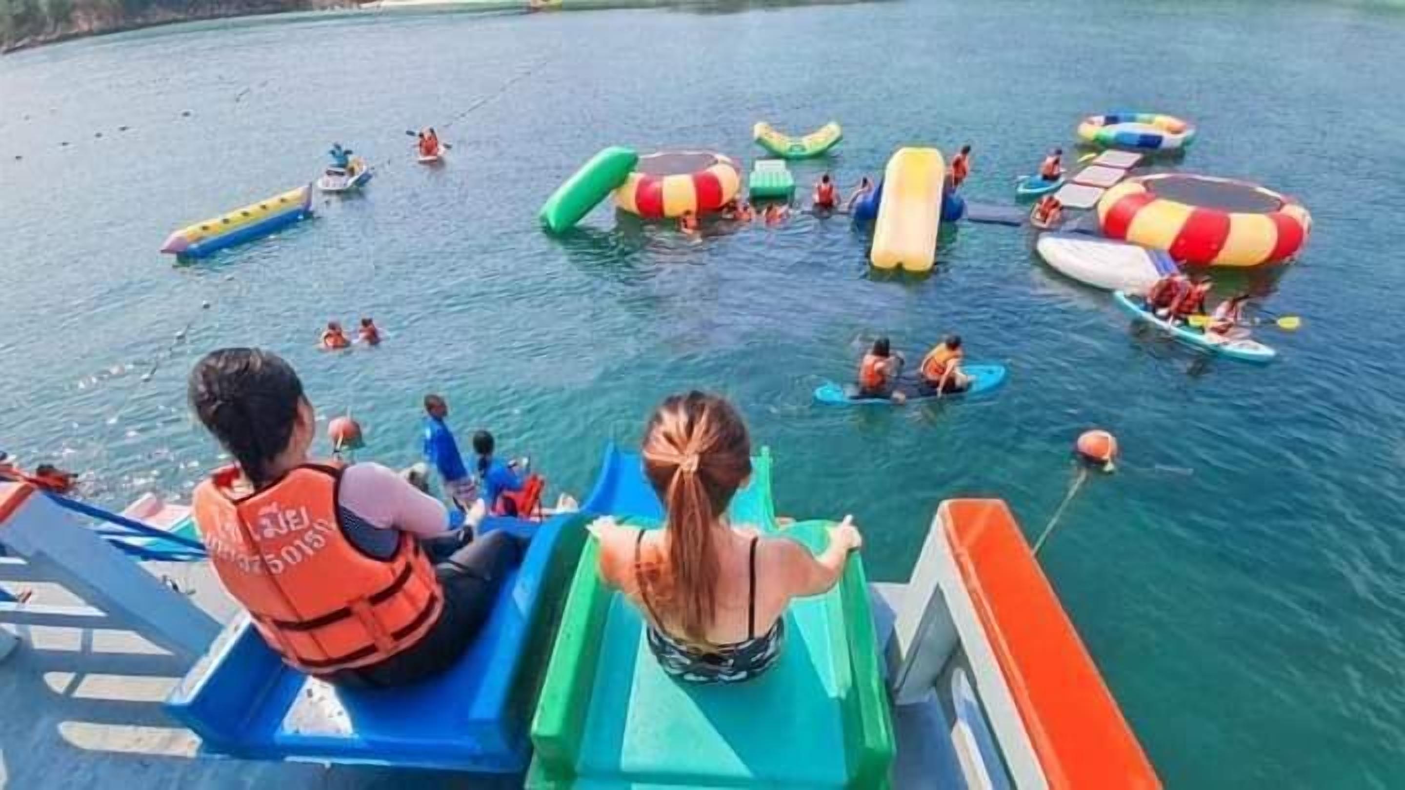 A water park with various water rides and inflatable structures.