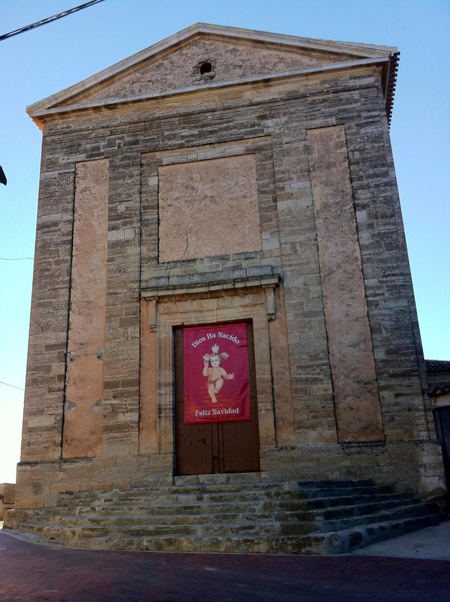 A building with a stone facade and a central entrance.