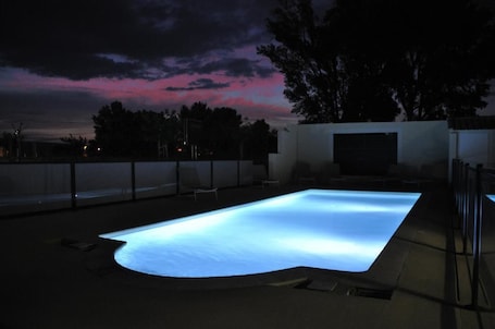 Una piscina al aire libre de temporada, sillones reclinables de piscina