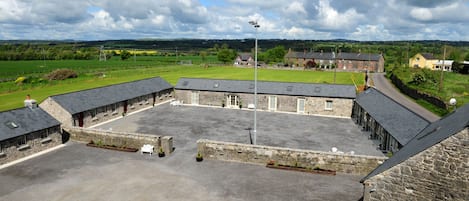 A stone building with multiple rooms and a large open courtyard.