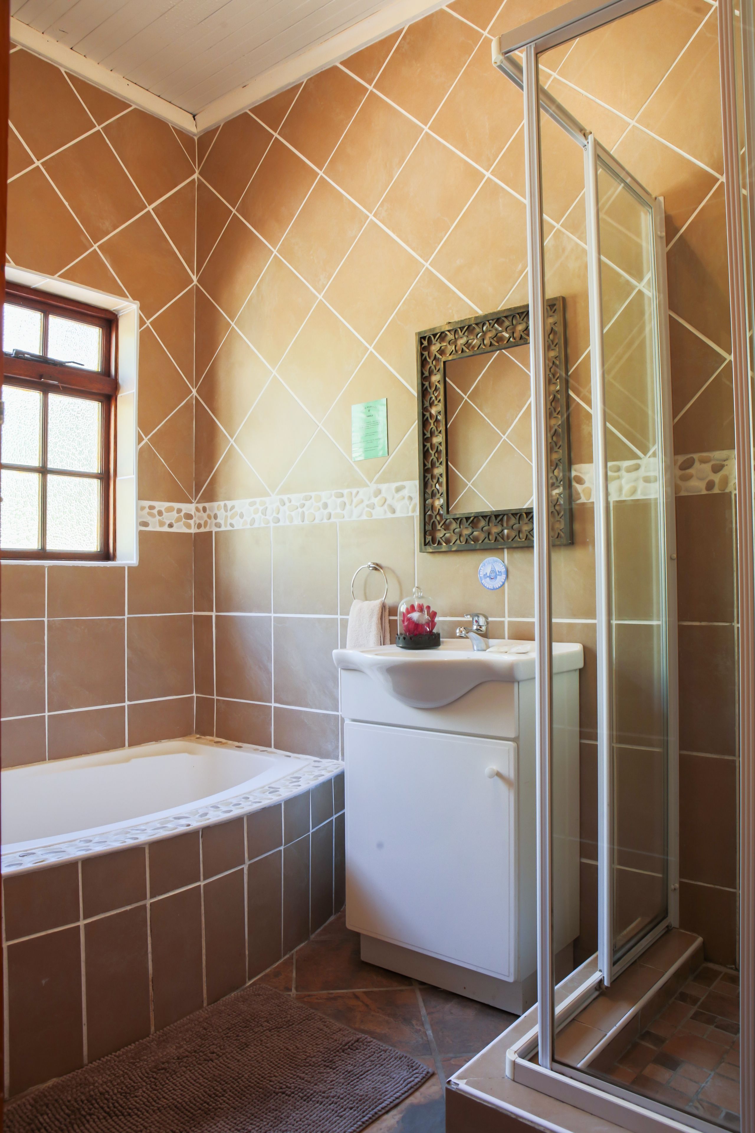 A bathroom with a bathtub, a shower, and a sink.