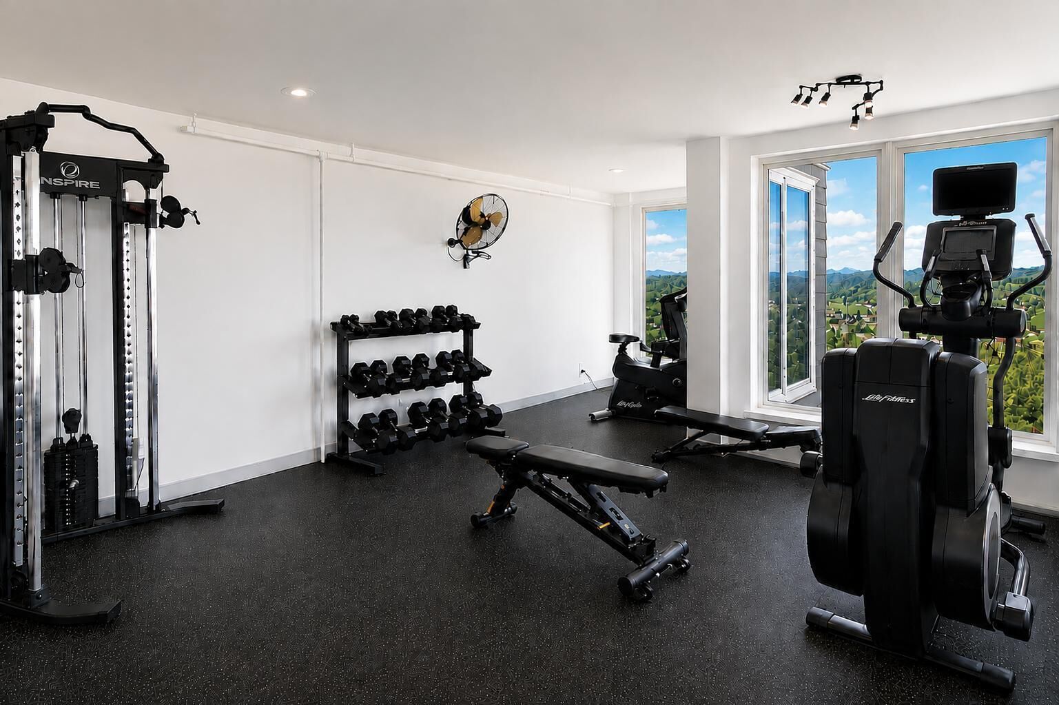 Une salle de sport équipée de matériel d’exercice, de supports à haltères et d’un tapis de course.