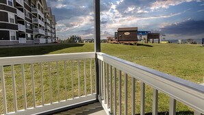 A hotel with a balcony, a grassy lawn, and a view of the ocean. - ML 110 - Appealing bike-in/out summer getaway! Minutes to bike trails! (Snowshoe)