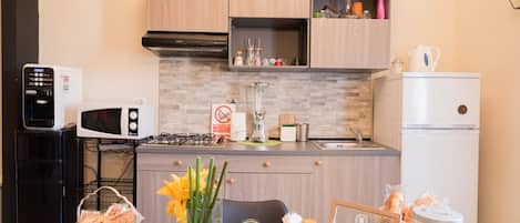 Fridge, microwave, stovetop, coffee/tea maker