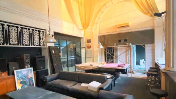 A modern lounge area with leather sofas, a billiards table, and a bar area with stools. - Wisma Tobana (Jakarta)