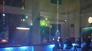 A billiards table with balls, a pool table, and a seating area with tables and chairs. - Wisma Tobana (Jakarta)