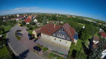 A residential area with a house featuring a large garage and a solar panel on the roof.