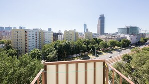 A cityscape with high-rise buildings, a clear sky, and a road with vehicles. - ShortStayPoland Aleja Solidarności - B61 (Warsaw)