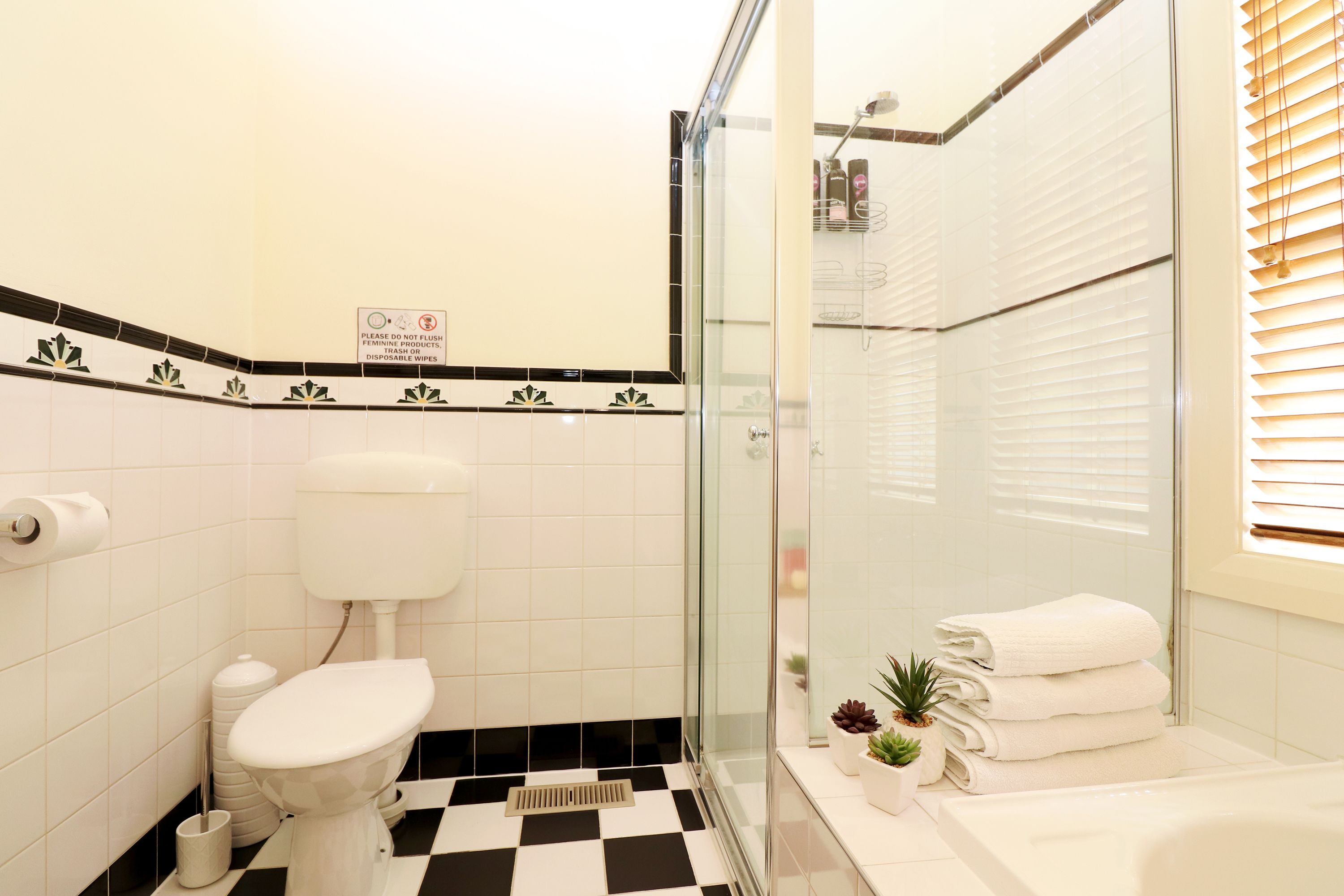 A bathroom with a toilet, bidet, and a glass shower enclosure.