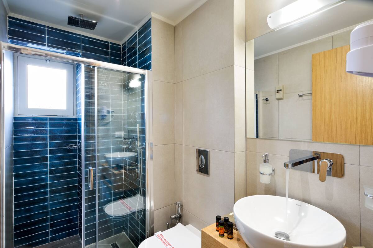 two bedroom suite with balcony | bathroom | shower, free toiletries, hair dryer, bathrobes